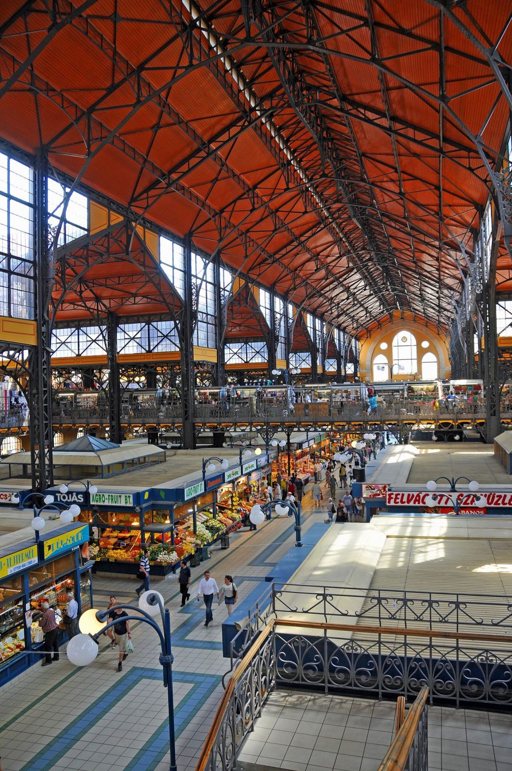 Indoor Market Halls Win Back Weekend Food Shoppers Stalls inside a bright indoor market hall selling fresh produce, bread, and flowers.