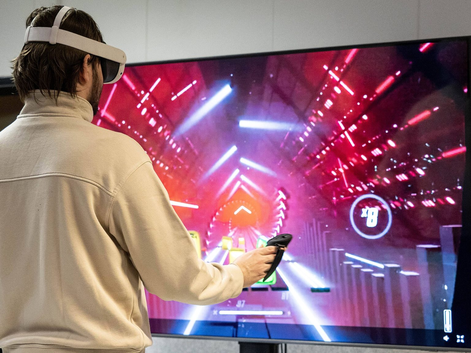 Virtuix Partners With Meta to Bundle Omni One VR Treadmills With Quest Headsets Person wearing a VR headset using an omnidirectional treadmill